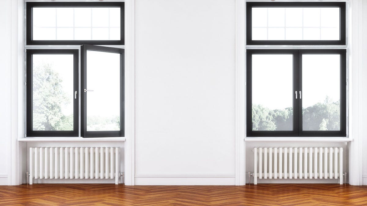 Two column white radiators under two windows