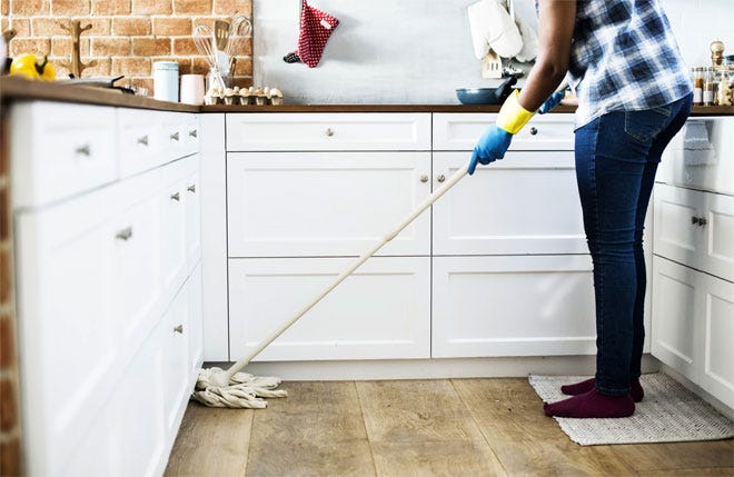 Cleaning the kitchen with a mop