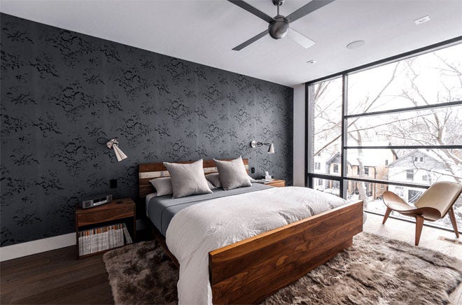 A contrast wall covered in dark wallpaper