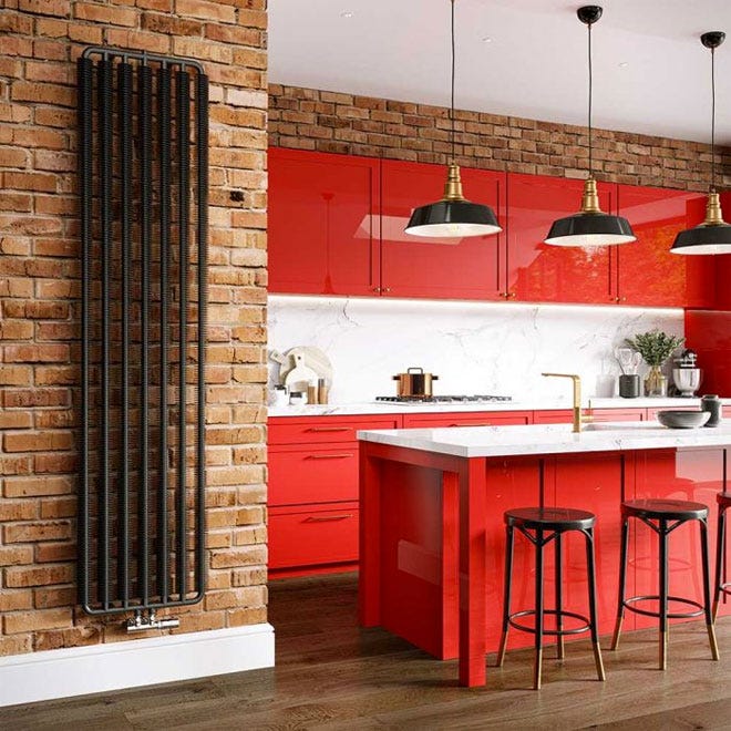 Trade Direct Ribbon Design Radiator in black set against a brick wall.