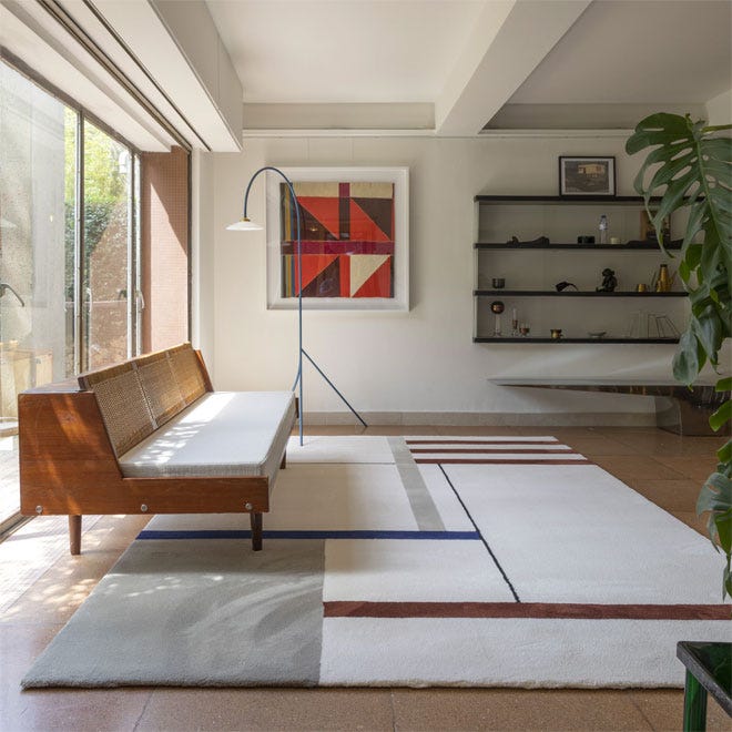A stylish home interior with a rug placed on a wooden floor.