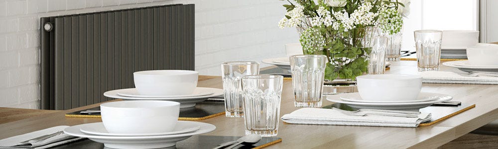 A horizontal anthracite kitchen radiator next to a dining table