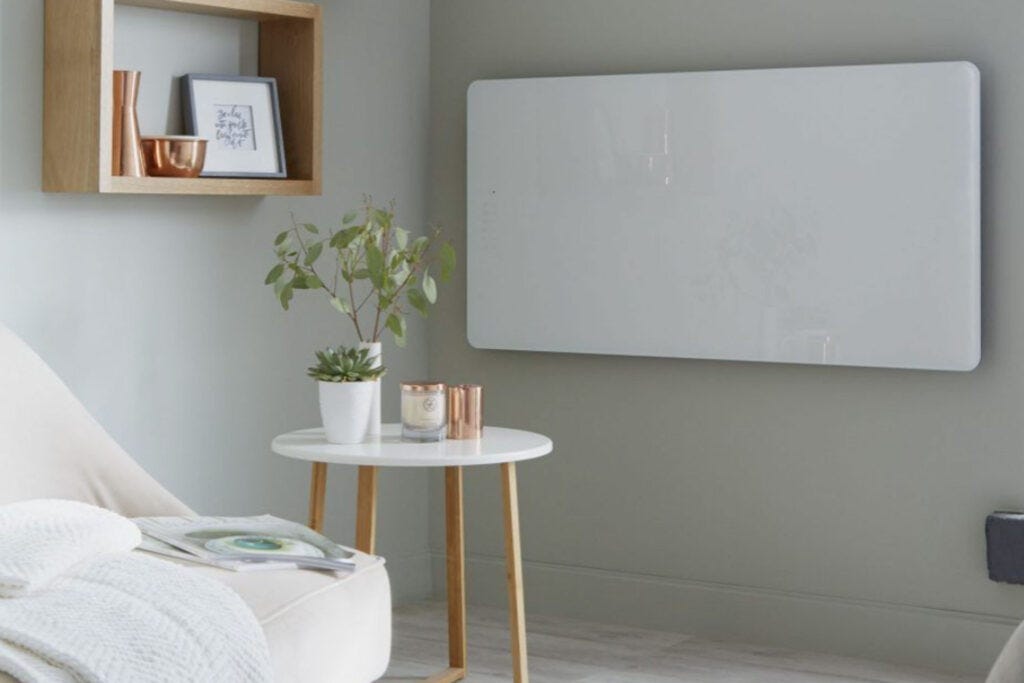 A glass electric panel radiator on a wall in a living room