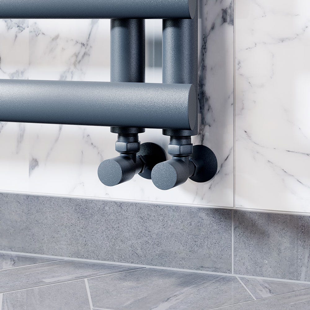 A modern silver and chrome angled thermostatic radiator valve