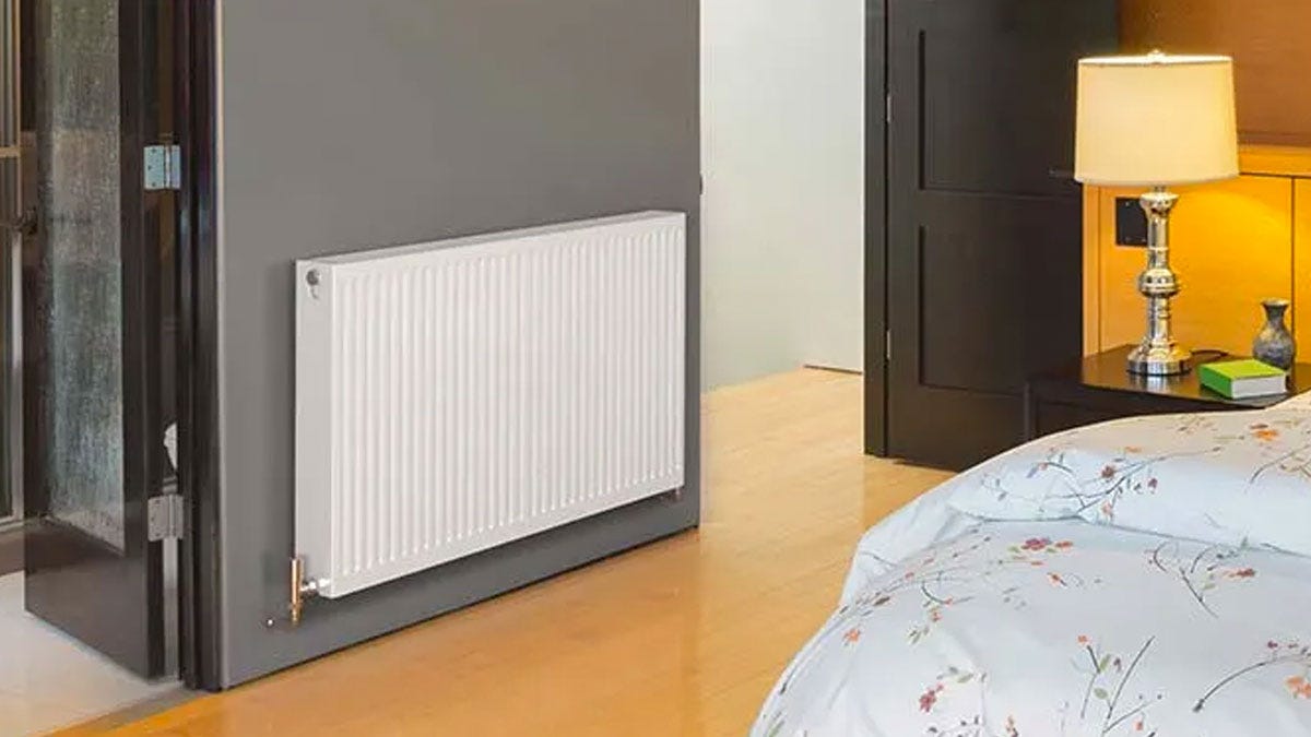 A convector radiator in a bedroom