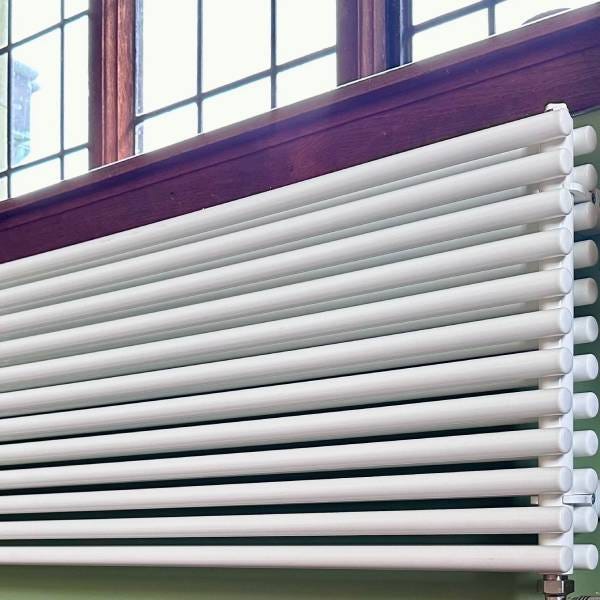 A white Nordic Round designer radiator