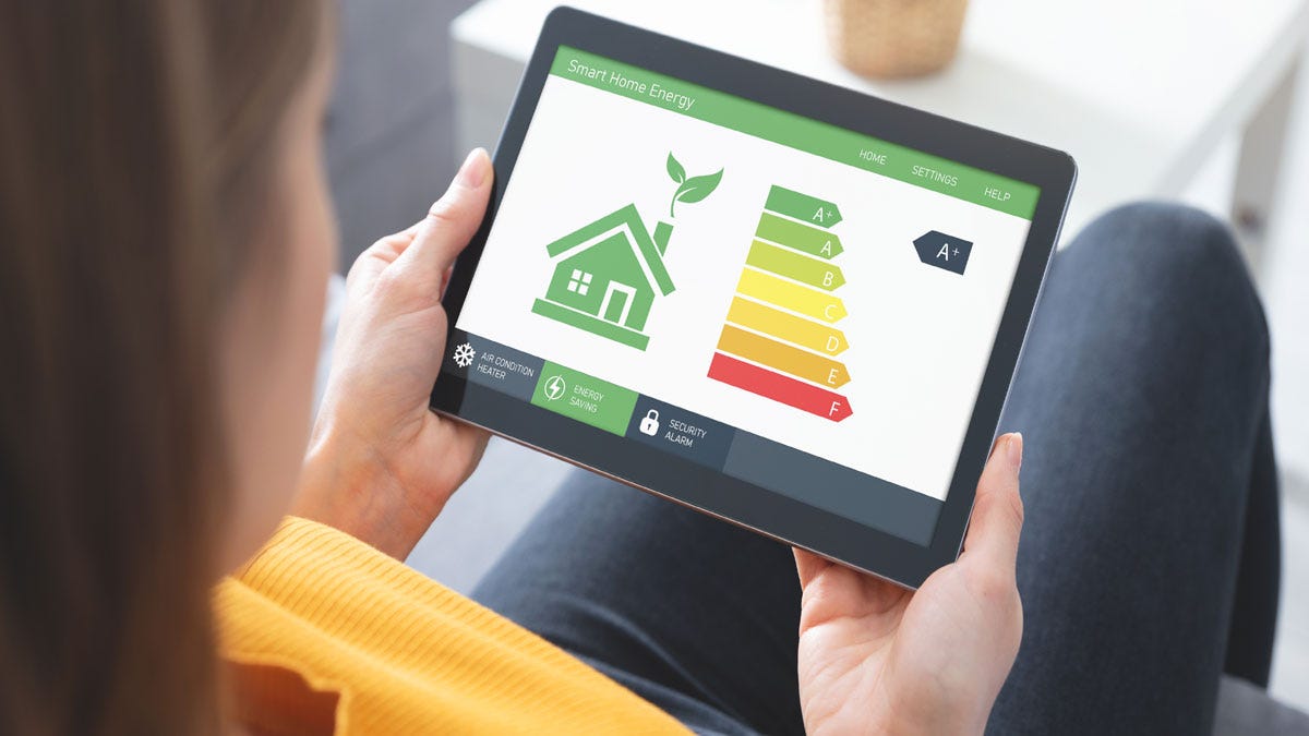 A woman checking her home's energy efficiency rating on an iPad