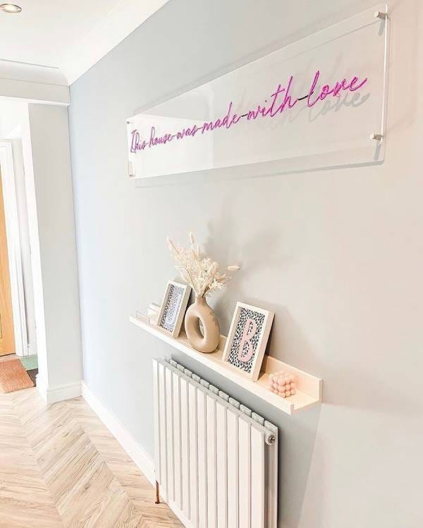 White designer radiator with shelf in a hallway