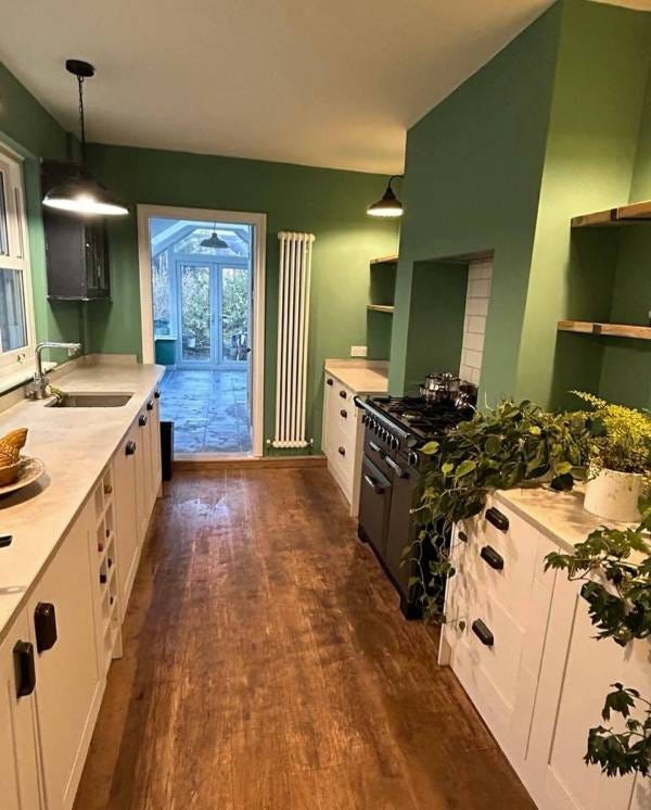 White Nordic Oslo vertical column radiator by the back door in a kitchen