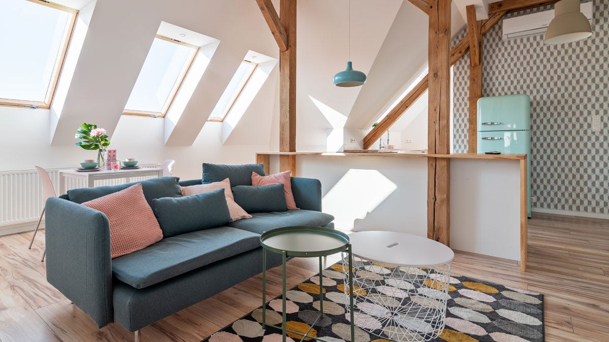 A converted loft apartment featuring a white convector radiator