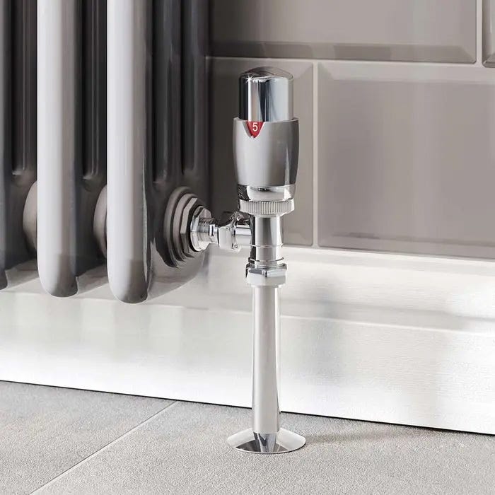 A modern silver and chrome angled thermostatic radiator valve