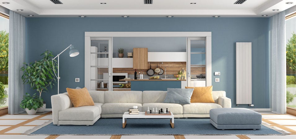 A stylish living room featuring a white, aluminium vertical radiator